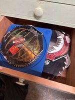 Drawer showing stack of Freud saw blades, some in packaging, one in blue plastic case