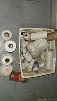 Bin containing assorted spools and jar of string/twine