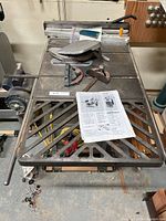 Top view of Rockwell Beaver table saw showing cast-iron top, rip fence, miter gauge, blade guard, manual