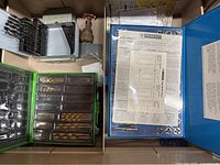 Open drawer showing Mastercraft tap & die set, Kawasaki bit set, packaged drill bits, grey drill bit index, brass valve