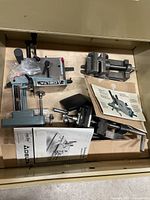 Drawer containing Delta mortising attachment, two vises, manuals and hardware