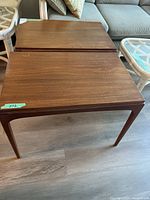 Two wooden side tables angled view