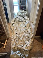 Car cover laid out along hallway showing full length