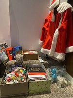 Overall lot showing Santa suit on hanger, boxes of cards and decorations, CDs