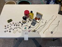 Group shot of all jewelry pieces and accessories on table