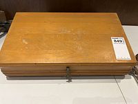 Closed wood cutlery chest with keyed latch