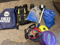 All items laid out showing dumbbell, stability ball material, backpack, drawstring bag, resistance bands, discs, cone, bar