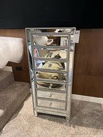 Front view showing seven drawers with mirror fronts and crystal knobs