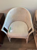 Front view of rattan armchair with cushion