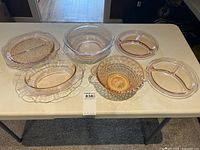 All seven rose glass pieces on table