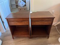 Two matching wooden side tables front view