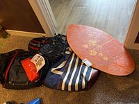 Group view of skimboard, backpacks, sleeping pad, cooler tote