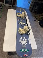 Full view of Ride Deluxe snowboard with bindings attached