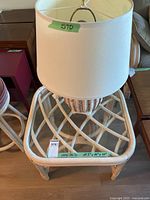 Side table with lamp showing overall lot