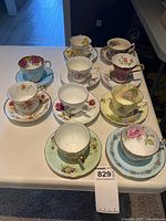 Group shot of all ten teacup and saucer sets