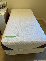 Twin mattress on box spring and frame