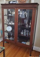 Full view of cabinet showing doors, shelves, and contents for scale