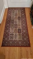 Full view of runner rug on wooden floor