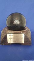 Cannonball on base showing commemorative plaque