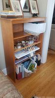 Front view of wooden bookcase with items on shelves