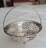 Overall view of sterling basket showing pierced design and handle
