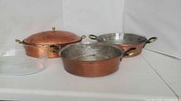 All components: two copper pans, domed lid, clear glass lid