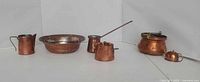All six copper items lined up for scale and type identification