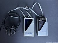 Player, case and headphones laid out together