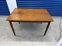 Full view of teak dining table top and legs