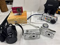 Group shot showing all five cameras, box and manual