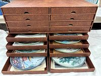 Organizer cabinet open showing multiple drawers with plates