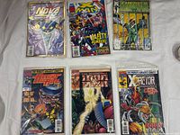 Six bagged comic books laid out