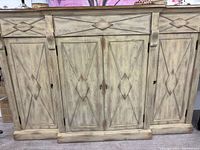 Front view of distressed wood sideboard cabinet with four doors and two drawers