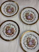 Group shot of four Limoges plates showing fronts