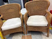 Front view of both rattan armchairs with cushions