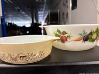 Both Pyrex bowls side-by-side showing size and pattern contrast