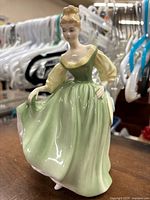 Front view of Royal Doulton Fair Lady figurine showing dress, pose and facial details