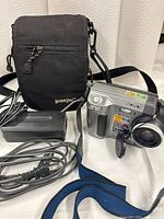 Overall view of camera, charger, cords and bag