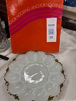 Plate in front of Anchor Hocking box showing top and gold rim