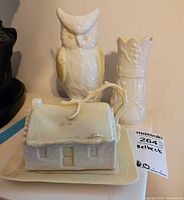 Front view showing owl vase, bamboo vase and cottage dish on plate