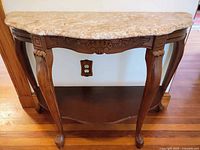 Full front view of console table showing hardwood frame, cabriole legs, lower shelf and marble top