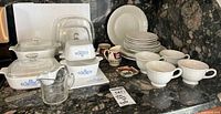overall lot showing CorningWare, glass lids, measuring cup, dinnerware and creamers