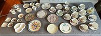 Entire lot laid out on table showing cups, saucers, plates, creamers and serving pieces