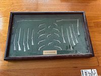 Front view of closed display case showing all miniatures through glazing