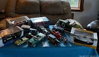 Overview of boxed and loose die-cast cars on table