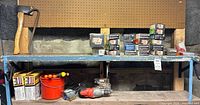 Overall view: drill, fastener boxes, axe, pry bar, bucket, screwdrivers