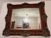 Front view of ornate carved gilt wall mirror