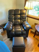 Recliner chair, ottoman, brass floor lamp in situ
