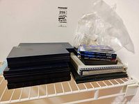 Stacked blue U.S. Mint proof set cases and smaller boxed sets on wire shelf