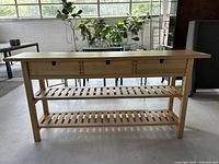 Front angled view showing full table with drawers and shelves